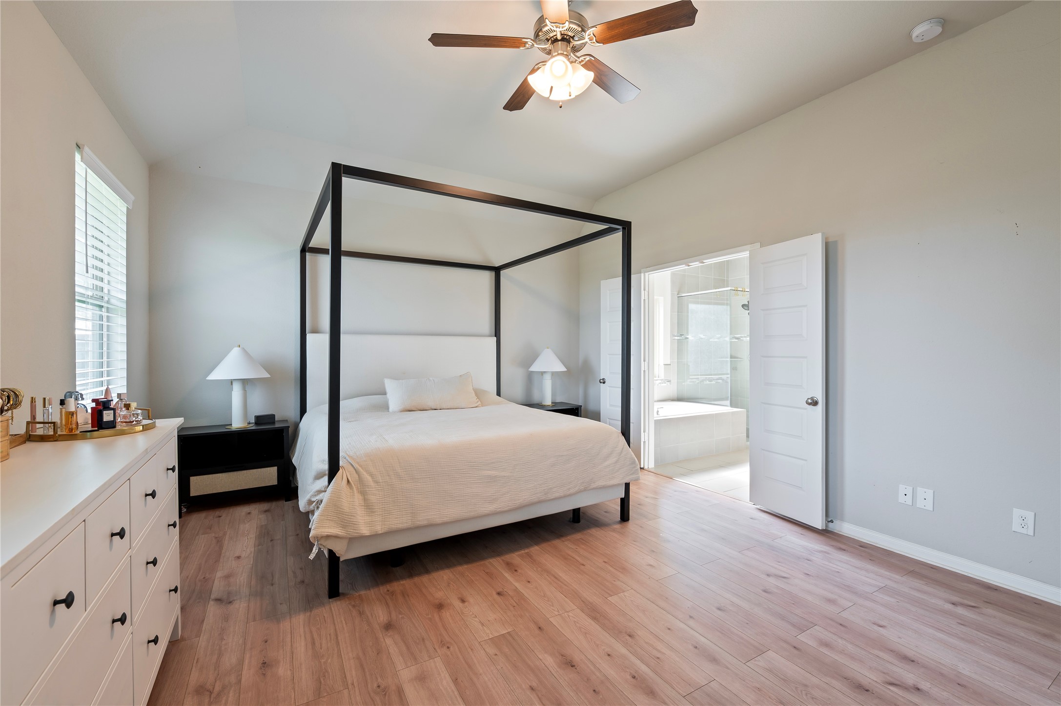 7802 Bellwick Court Pasadena, TX 77505 - Photo 21 of 37 a bedroom with a bed and a chandelier