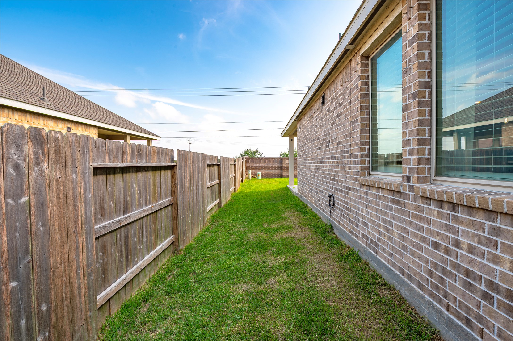 7802 Bellwick Court Pasadena, TX 77505 - Photo 33 of 37 a backyard of a house with plants and wooden fence
