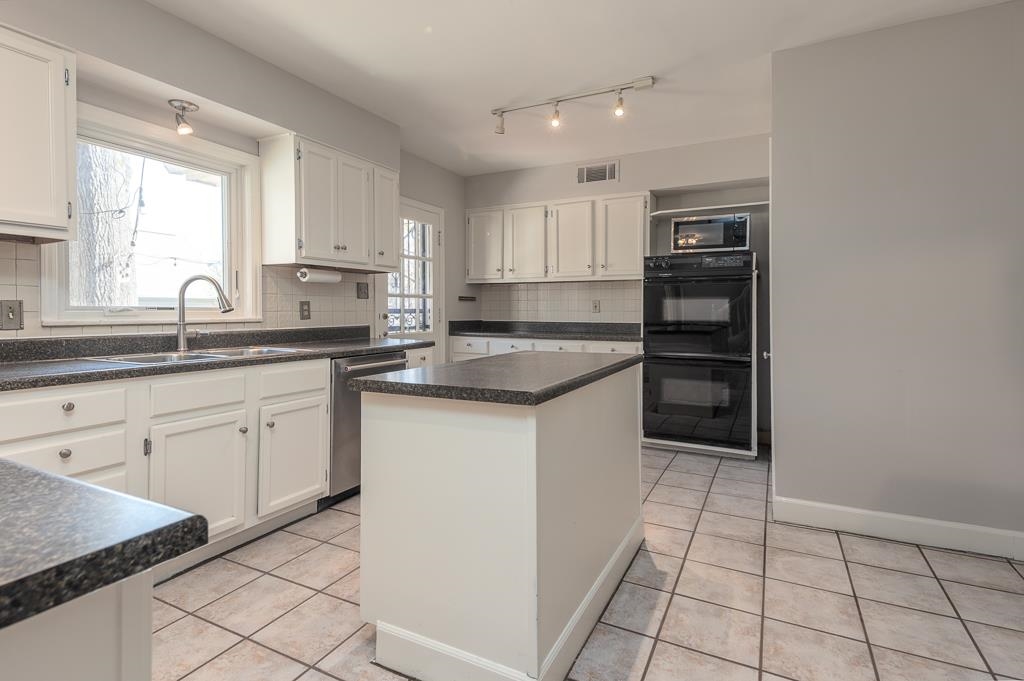500 Colonial Road Memphis, TN 38117 - Photo 11 of 35 a kitchen with stainless steel appliances granite countertop a sink stove and cabinets
