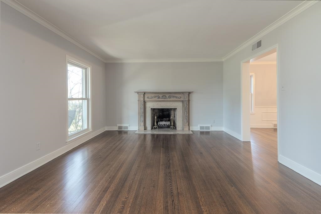 500 Colonial Road Memphis, TN 38117 - Photo 19 of 35 an empty room with wooden floor fireplace and windows
