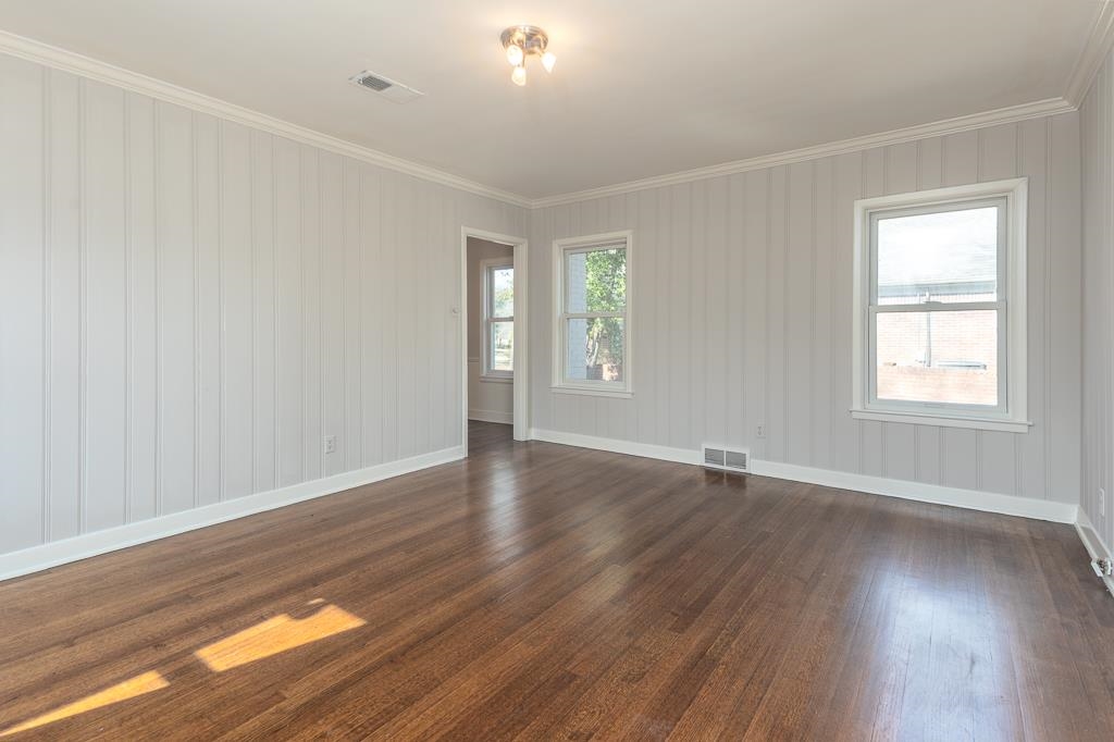 500 Colonial Road Memphis, TN 38117 - Photo 21 of 35 an empty room with wooden floor and windows