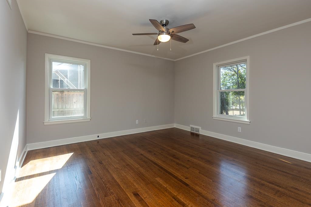500 Colonial Road Memphis, TN 38117 - Photo 26 of 35 a view of an empty room with wooden floor and a window