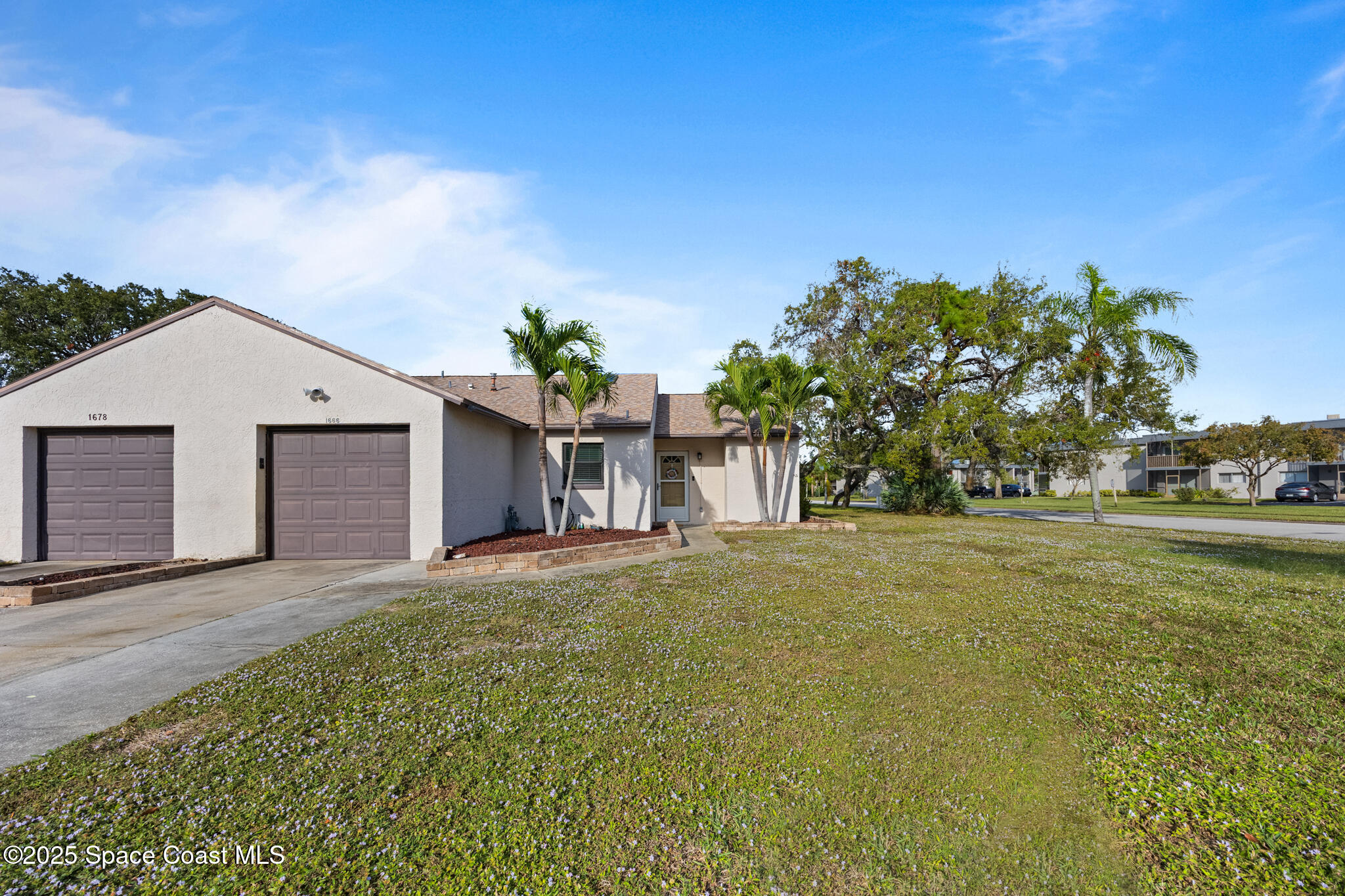 1666 Owl Lane Melbourne, FL 32935 - Photo 1 of 19 a front view of a house with a yard and garage