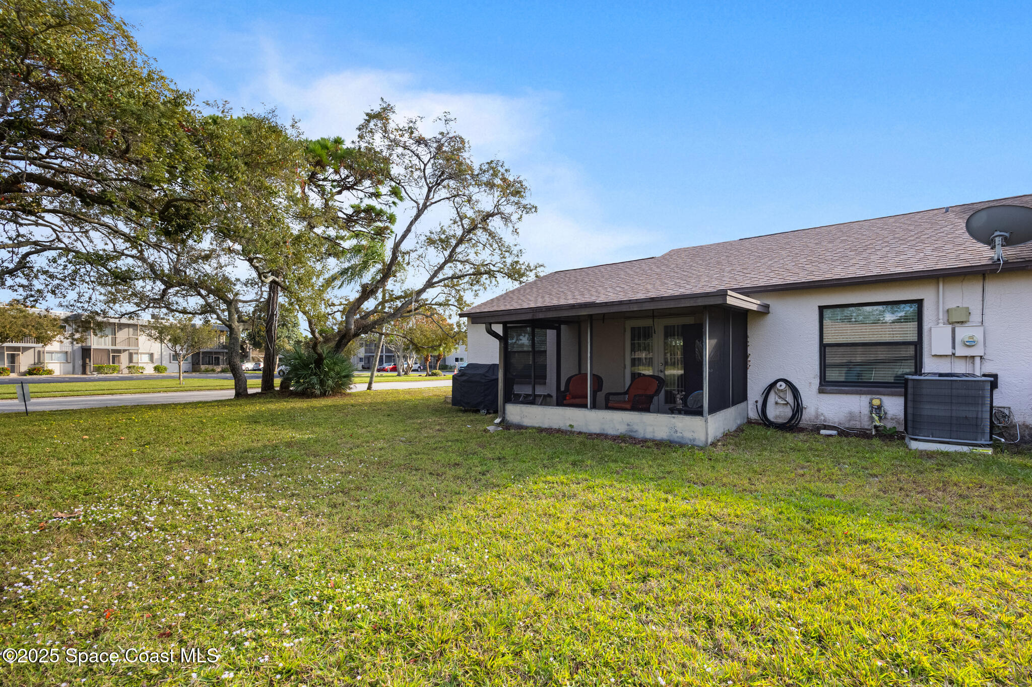 1666 Owl Lane Melbourne, FL 32935 - Photo 19 of 19 a view of a house with a garden and trees