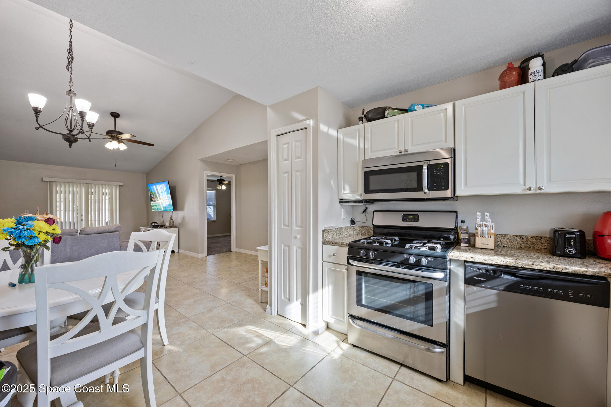 1666 Owl Lane Melbourne, FL 32935 - Photo 8 of 19 a kitchen with a stove a microwave and cabinets