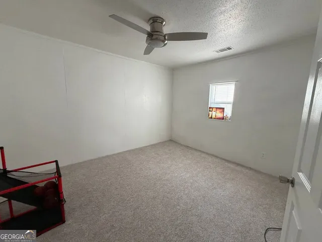 a view of an empty room and a window