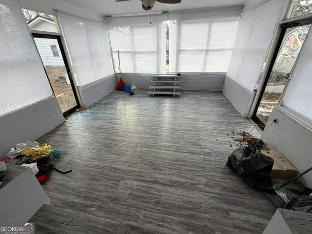 a view of entryway with wooden floor and stairs