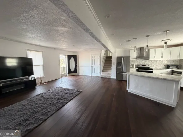 a living room with furniture and a flat screen tv
