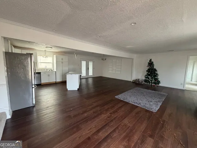 a view of an empty room and wooden floor