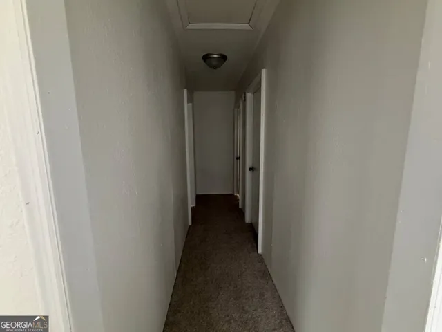 a view of a hallway with a door