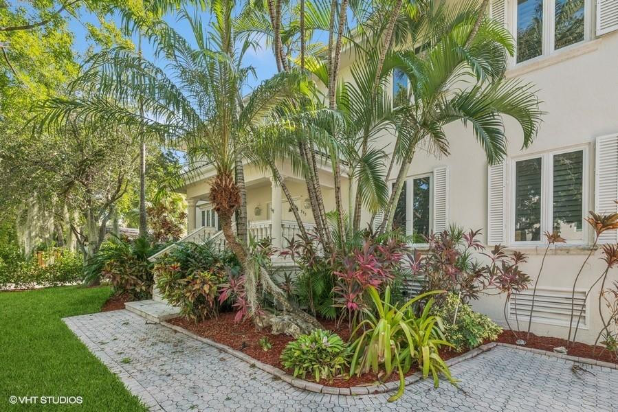 375 Ridgewood Road Key Biscayne, FL 33149 - Photo 3 of 77 a front view of a house with a garden