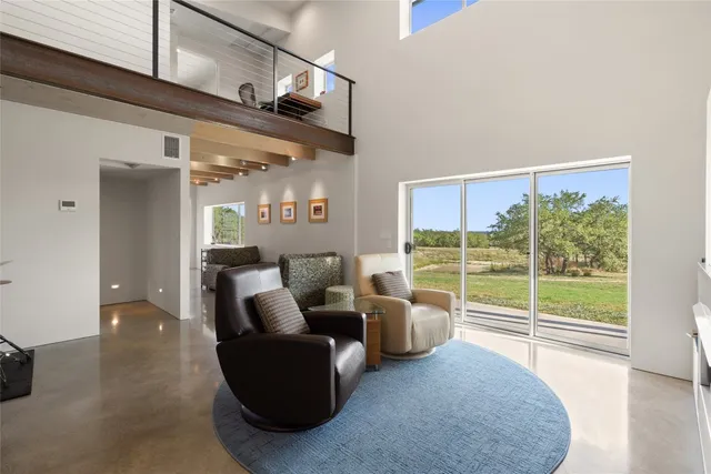 a living room with furniture and stairs