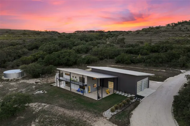 a view of a balcony with chairs and wooden floor