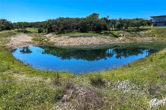 a view of a lake with a house in the background