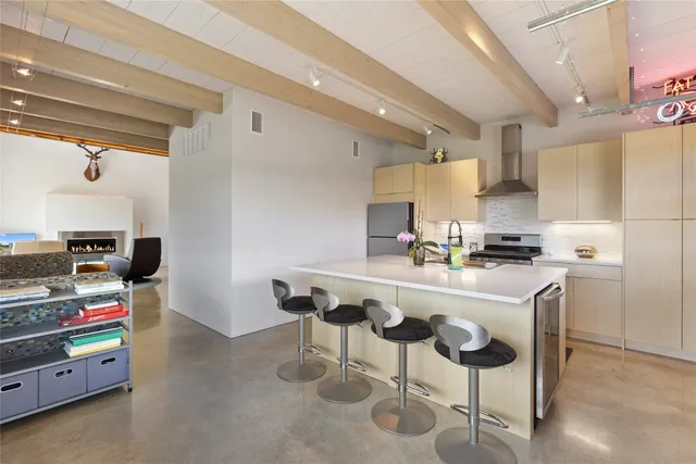 a kitchen with cabinets and chairs