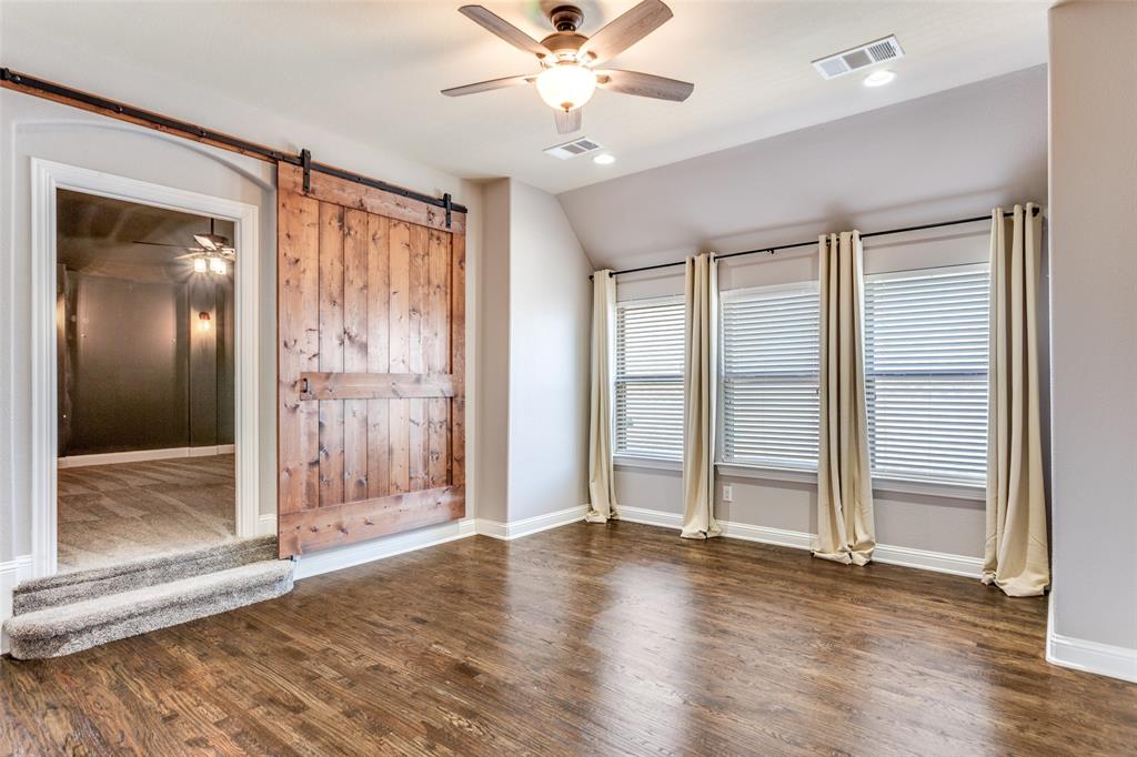 1505 5th Street Argyle, TX 76226 - Photo 18 of 25 an empty room with wooden floor fan and windows