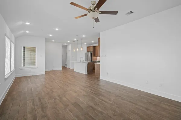 a view of a kitchen with a sink and a refrigerator
