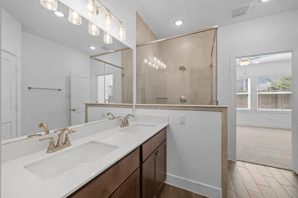 a bathroom with a double vanity sink mirror and double
