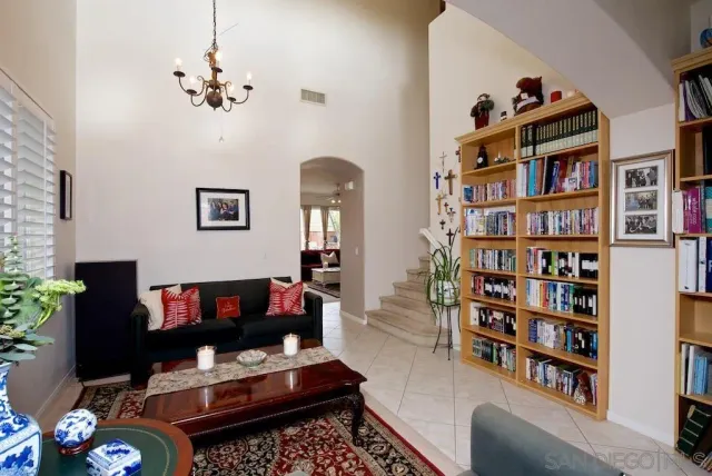 a living room with furniture and a book shelf