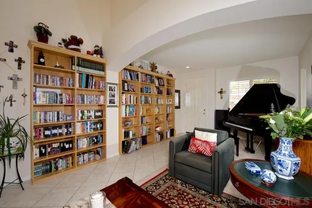 a living room with furniture and a book shelf