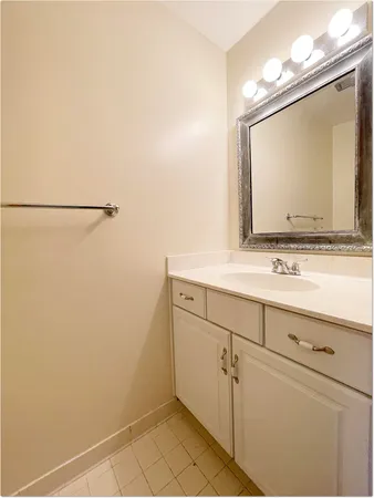 a bathroom with a sink vanity and mirror