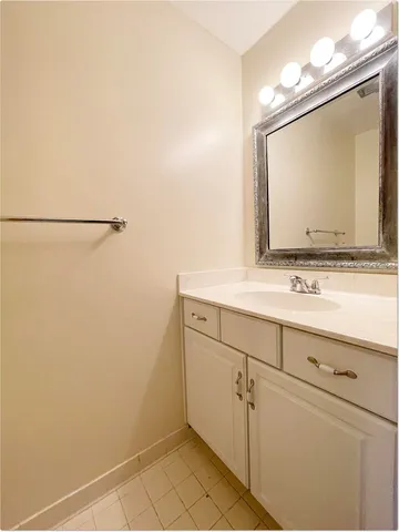 a bathroom with a sink vanity and mirror