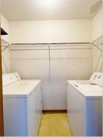 a utility room with a washer dryer and washer