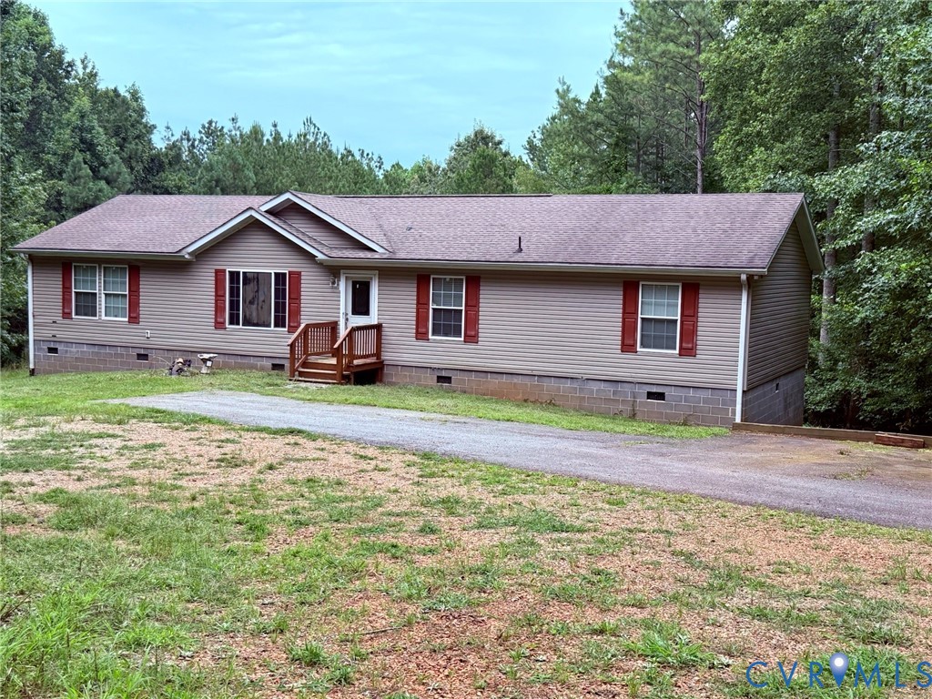 a view of a house with a big yard and large tree