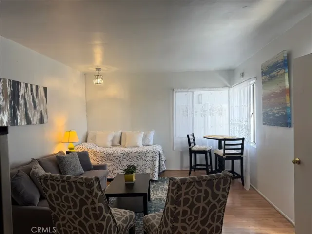 a bedroom with furniture and wooden floor