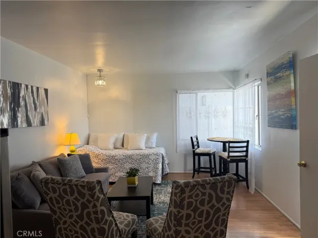 a bedroom with furniture and wooden floor