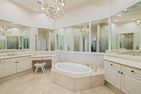 a bathroom with a tub a sink shower and mirror