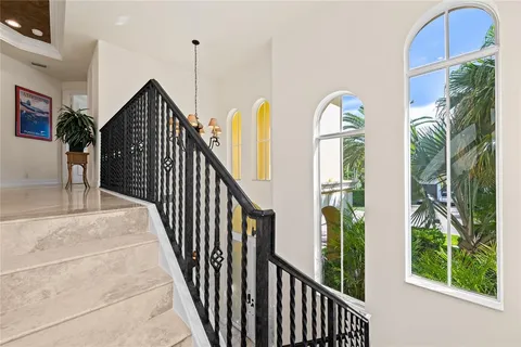 a view of staircase with railing and plants