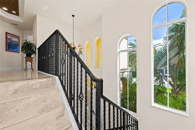 a view of staircase with railing and plants