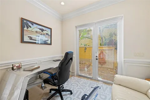 a view of a livingroom with workspace and a window