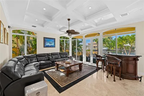 a living room with furniture ceiling fan and a large window