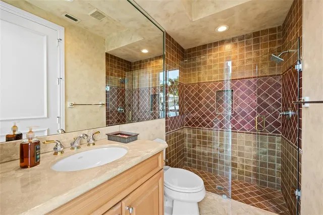 a bathroom with a sink toilet and shower