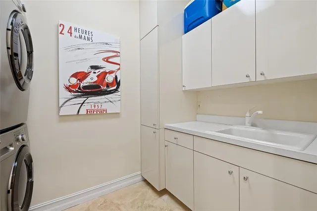 a utility room with sink dryer and washer
