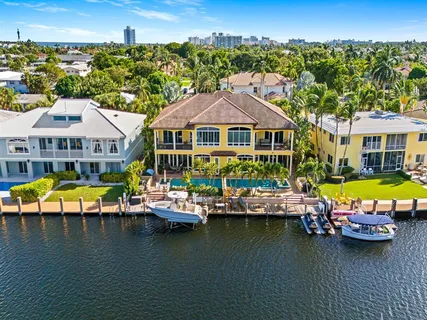 a view of a swimming pool with lounge chair in front of house