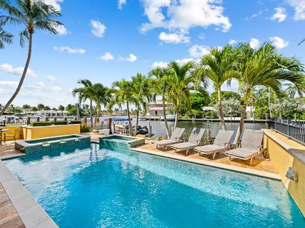 a view of a swimming pool with a table and chairs