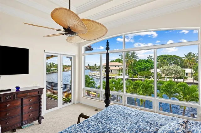 a bedroom with furniture and a large window