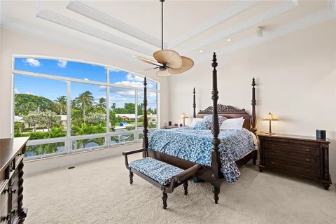 a living room with a bed furniture and a large window