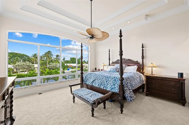 a living room with a bed furniture and a large window