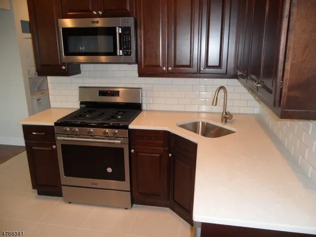 a kitchen with a refrigerator and window