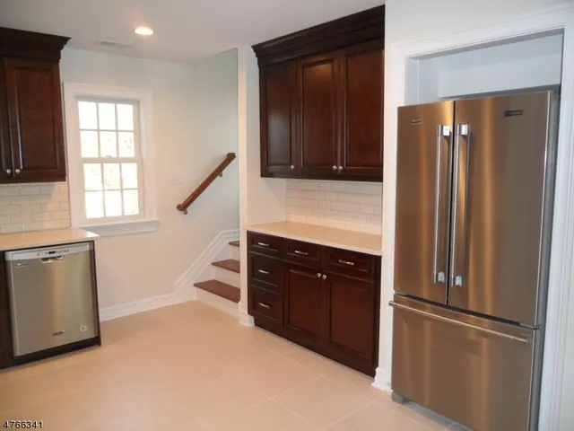 a kitchen with stainless steel appliances a stove a microwave a sink and cabinets