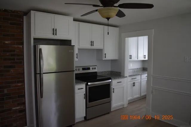 a kitchen with stainless steel appliances a refrigerator sink and cabinets