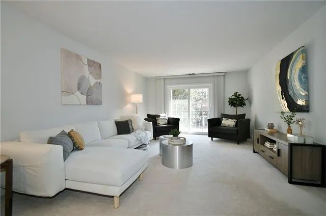 a living room with furniture a fireplace and a potted plant