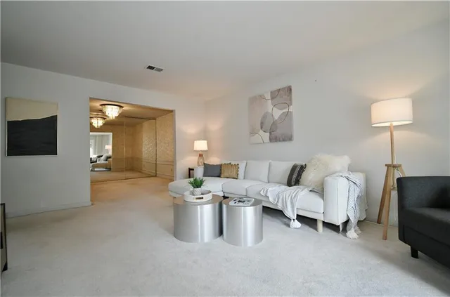 a living room with furniture and a lamp