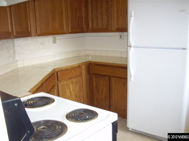 1865-7 Montello Street Reno, NV 89512 - Photo 4 of 9 a kitchen with a sink and a refrigerator