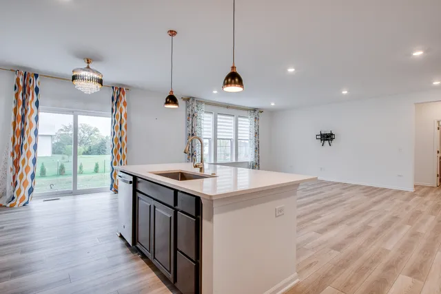 a kitchen with a stove and a wooden floor