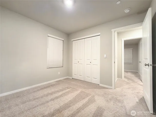 a view of a livingroom with wooden floor and bathroom